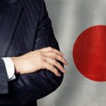 Ręce mężczyzn na tle japońskiej flagi tło biznes polityka i edukacja w Japonii koncepcja