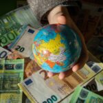 Euro jako waluta Unii Europejskiej i model globusa w ręku